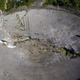 Aerial photo showing a massive gash in the radar dish and the receiving platform resting along the edge of the 1,000-foot-wide (305-meter) structure.